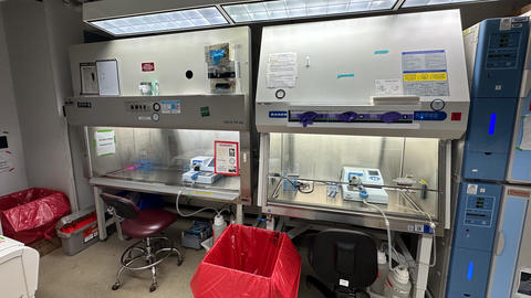 Two biosafety cabinets each with a Combi liquid handler inside 