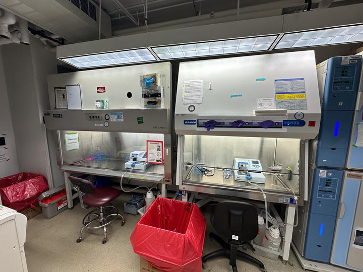 Two biosafety cabinets each with a Combi liquid handler inside 